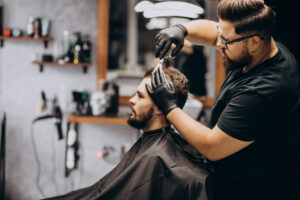 client doing hair cut at a barber shop salon